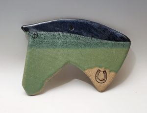 Horsehead ornament in dark blue and green with a horseshoe